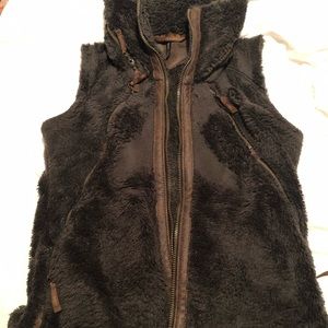Kuhn women’s fleece vest with hood and leather accents.